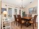 Elegant dining room featuring a wood table and chandelier at 18305 Wolbrette Cir, Port Charlotte, FL 33948