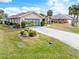 Single story home with attached garage and landscaped front yard at 18305 Wolbrette Cir, Port Charlotte, FL 33948