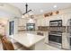 Modern kitchen with an island, stainless steel appliances and light cabinets at 18305 Wolbrette Cir, Port Charlotte, FL 33948