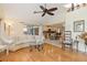 Living room with hardwood floors, a view of the kitchen, and access to the patio at 18305 Wolbrette Cir, Port Charlotte, FL 33948