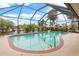 Relaxing screened pool and patio area overlooking a canal at 18305 Wolbrette Cir, Port Charlotte, FL 33948