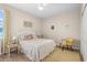 Guest bedroom with queen-size bed, and yellow accent chair at 1966 Trout Cir, Englewood, FL 34224