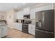 Modern kitchen with white cabinets, stainless steel appliances, and granite countertops at 1966 Trout Cir, Englewood, FL 34224