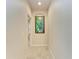 Bright hallway with tropical artwork at 2064 El Cerito Ct, Punta Gorda, FL 33950