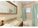 Bathroom with single vanity, granite countertop, and shower/tub combo at 2064 El Cerito Ct, Punta Gorda, FL 33950