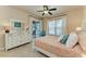 Comfortable bedroom with dresser, queen-size bed, and access to patio at 2064 El Cerito Ct, Punta Gorda, FL 33950