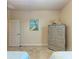 Bedroom with twin beds, dresser, and access to bathroom at 2064 El Cerito Ct, Punta Gorda, FL 33950