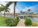 Private boat dock with pathway, lush landscaping, and canal access at 2064 El Cerito Ct, Punta Gorda, FL 33950