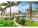 Private boat dock with pathway, lush landscaping, and canal access at 2064 El Cerito Ct, Punta Gorda, FL 33950