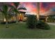 Well-maintained house with lush landscaping at sunset at 2064 El Cerito Ct, Punta Gorda, FL 33950