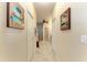 Well-lit hallway with access to bathroom and bedrooms at 2064 El Cerito Ct, Punta Gorda, FL 33950