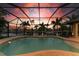 Enclosed pool and patio area at sunset, overlooking canal at 2064 El Cerito Ct, Punta Gorda, FL 33950