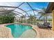 Enclosed pool and patio area with canal view and lounge chairs at 2064 El Cerito Ct, Punta Gorda, FL 33950