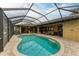 Enclosed pool and patio with canal view, lounge chairs, and seating at 2064 El Cerito Ct, Punta Gorda, FL 33950