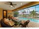 Covered patio with seating area and view of pool and canal at 2064 El Cerito Ct, Punta Gorda, FL 33950