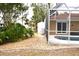 View of the screened-in pool area, landscaped yard, and outdoor shed at 21217 Knollwood Ave, Port Charlotte, FL 33952