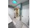 Bathroom features a shower stall, decorative tile flooring, and a bright solar tube at 21217 Knollwood Ave, Port Charlotte, FL 33952