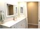 Bright bathroom featuring laminate floors, a vanity, a mirror, and a soft color scheme at 21217 Knollwood Ave, Port Charlotte, FL 33952