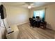 Bright bedroom featuring a desk with computer, laminate flooring, and ample workspace at 21217 Knollwood Ave, Port Charlotte, FL 33952