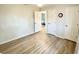 Bright bedroom with laminate floors, white walls, and view to another room at 21217 Knollwood Ave, Port Charlotte, FL 33952