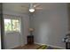 Bedroom with ceiling fan, window, and neutral wall color at 21217 Knollwood Ave, Port Charlotte, FL 33952