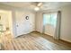 Comfortable bedroom featuring laminate floors, a ceiling fan, and a window with drapes at 21217 Knollwood Ave, Port Charlotte, FL 33952