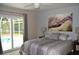 Spacious bedroom with pool view, large bed, and stylish decor at 21217 Knollwood Ave, Port Charlotte, FL 33952