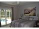 Main bedroom with sliding glass doors leading to the pool at 21217 Knollwood Ave, Port Charlotte, FL 33952