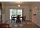 Dining room with hardwood floors, oval table, and access to a screened patio at 21217 Knollwood Ave, Port Charlotte, FL 33952