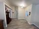 Hallway with hardwood floors, coat rack, and white interior doors at 21217 Knollwood Ave, Port Charlotte, FL 33952