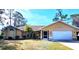 Well-maintained house with a two-car garage and landscaped lawn at 21217 Knollwood Ave, Port Charlotte, FL 33952