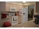 White appliances and light wood cabinets in this eat-in kitchen at 21217 Knollwood Ave, Port Charlotte, FL 33952