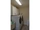 Laundry room with washer, dryer, and upper cabinets at 21217 Knollwood Ave, Port Charlotte, FL 33952