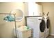 Functional laundry room with white washer and dryer, a utility sink, and ample cabinet space at 21217 Knollwood Ave, Port Charlotte, FL 33952