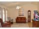 Relaxing living room featuring leather furniture and a large ceiling fan at 21217 Knollwood Ave, Port Charlotte, FL 33952