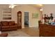 Living room with hardwood floors, leather furniture, and a view into the bedroom at 21217 Knollwood Ave, Port Charlotte, FL 33952