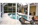 Screened in pool with a seating area and sliding glass doors to the home at 21217 Knollwood Ave, Port Charlotte, FL 33952