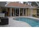 Relaxing pool area with patio furniture and screened enclosure at 21217 Knollwood Ave, Port Charlotte, FL 33952