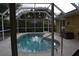 Inviting kidney-shaped pool with screened enclosure at 21217 Knollwood Ave, Port Charlotte, FL 33952