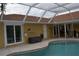 Large screened-in pool with patio and storage at 21217 Knollwood Ave, Port Charlotte, FL 33952