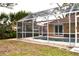 Screened pool enclosure with view of surrounding yard at 21217 Knollwood Ave, Port Charlotte, FL 33952