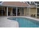 Inviting kidney-shaped pool with screened patio at 21217 Knollwood Ave, Port Charlotte, FL 33952