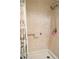 Shower featuring beige tiling, adjustable shower head and safety rail at 21217 Knollwood Ave, Port Charlotte, FL 33952