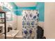 Clean bathroom with a teal accent wall and shower/tub combo at 21354 Austin Ave, Port Charlotte, FL 33952