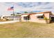 Ranch style home with a well-maintained lawn and American flag at 21354 Austin Ave, Port Charlotte, FL 33952