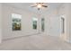 Bright bedroom with window, patio access, and neutral carpet at 240 W End Dr # 212, Punta Gorda, FL 33950