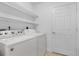 Laundry room with washer, dryer, and shelving for storage at 240 W End Dr # 212, Punta Gorda, FL 33950