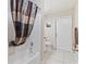 Bathroom with shower/tub combo and patterned curtain at 2411 Altoona Ave, North Port, FL 34286