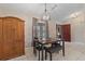 Dining area with wooden cabinet and small table with bench at 2411 Altoona Ave, North Port, FL 34286