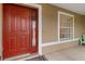 Red front door with sidelights and American flag decal at 2411 Altoona Ave, North Port, FL 34286